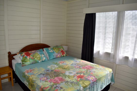 master bedroom with queen size bed at MAcs Shack